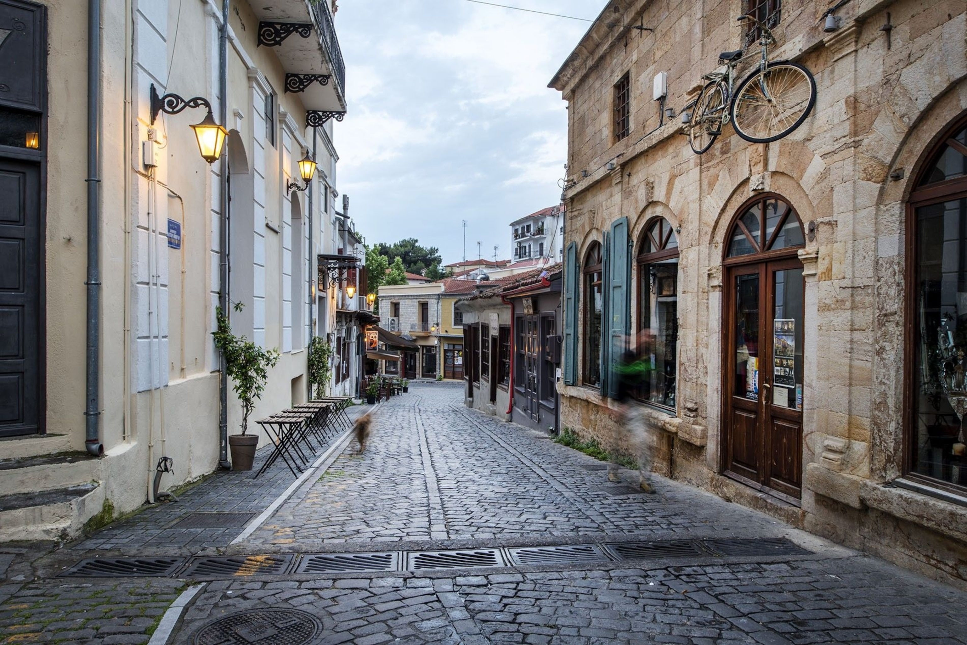 Visit Xanthi's Old Town during the autumn festival or February’s colourful carnival. On the right, a city bicycle is suspended above a door.