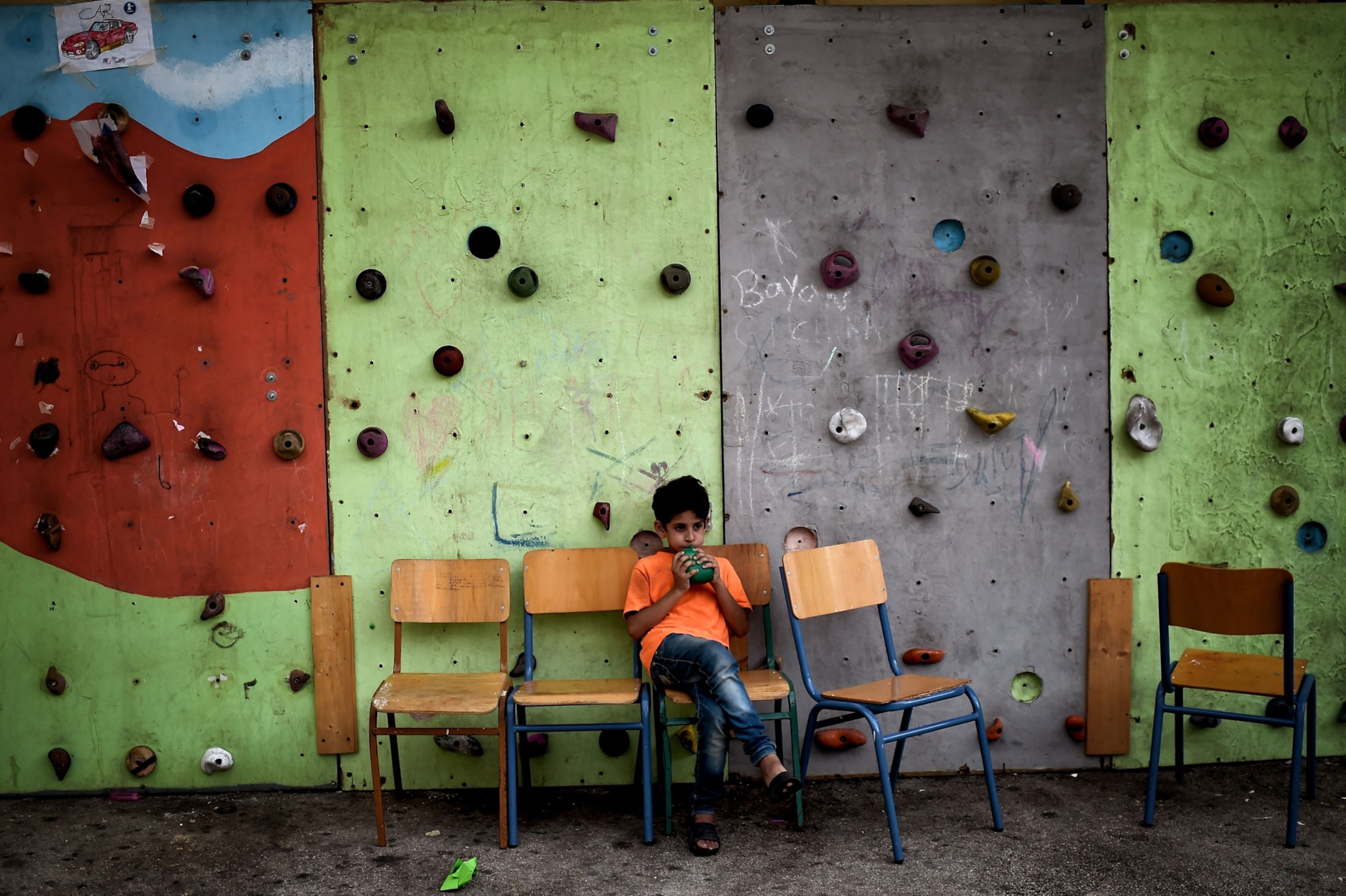 a Syrian boy sitting at a school in Athens