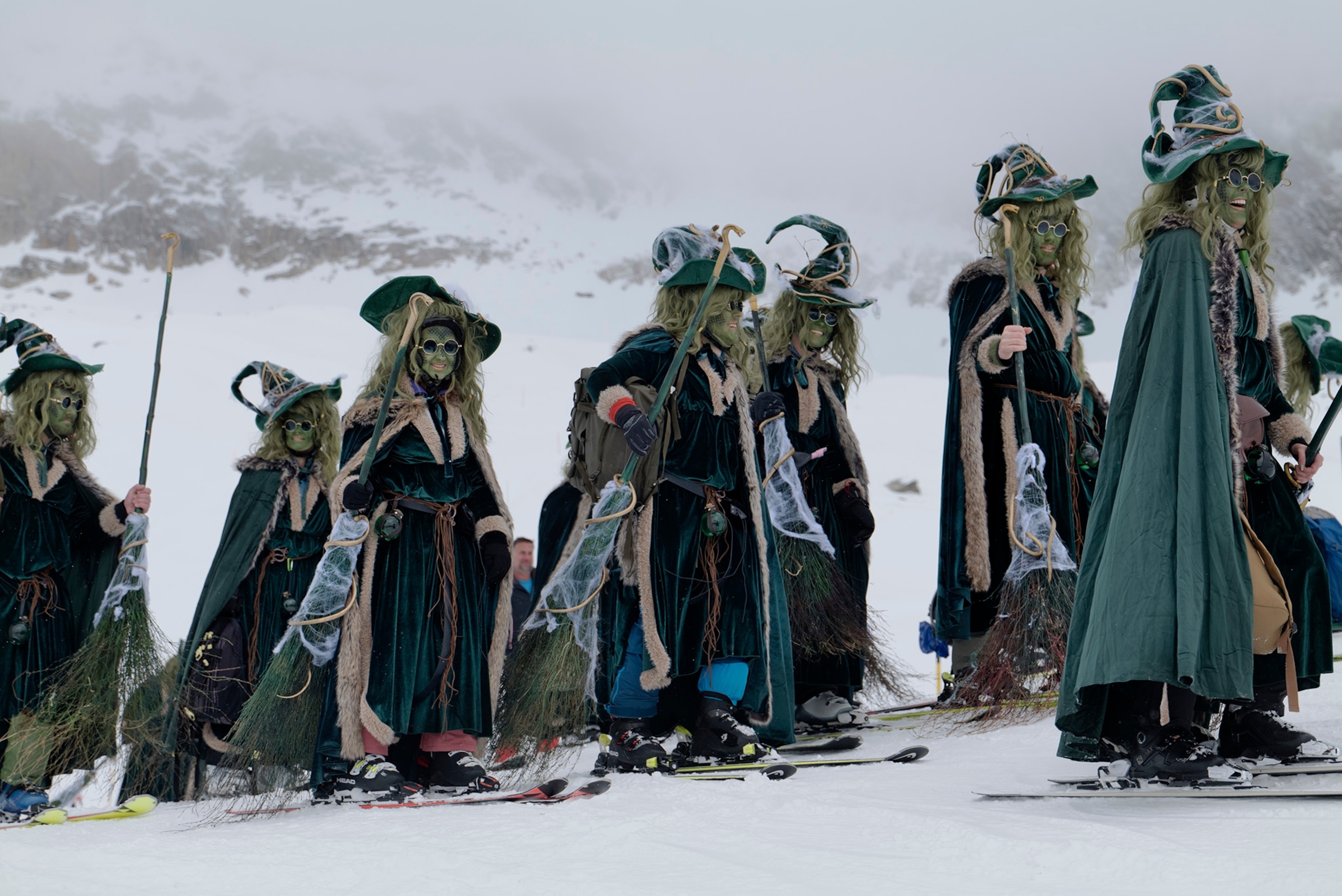 A team of witched dressed in matching witch costumes arrive at the top of the slops at the Belalp Hexen festival in Belalp, Switzerland. The festival includes races and witch themed activities.