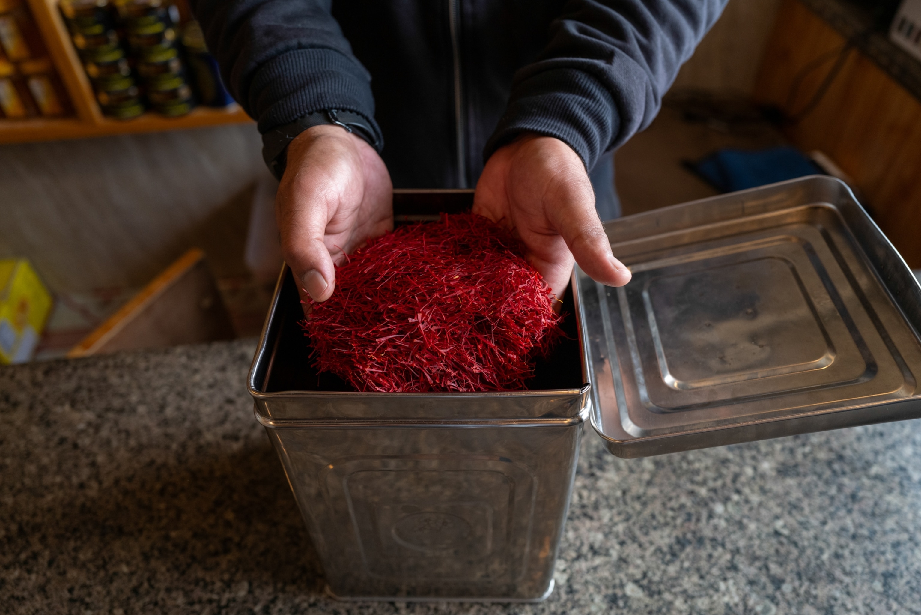 A man holds saffron in his hands.