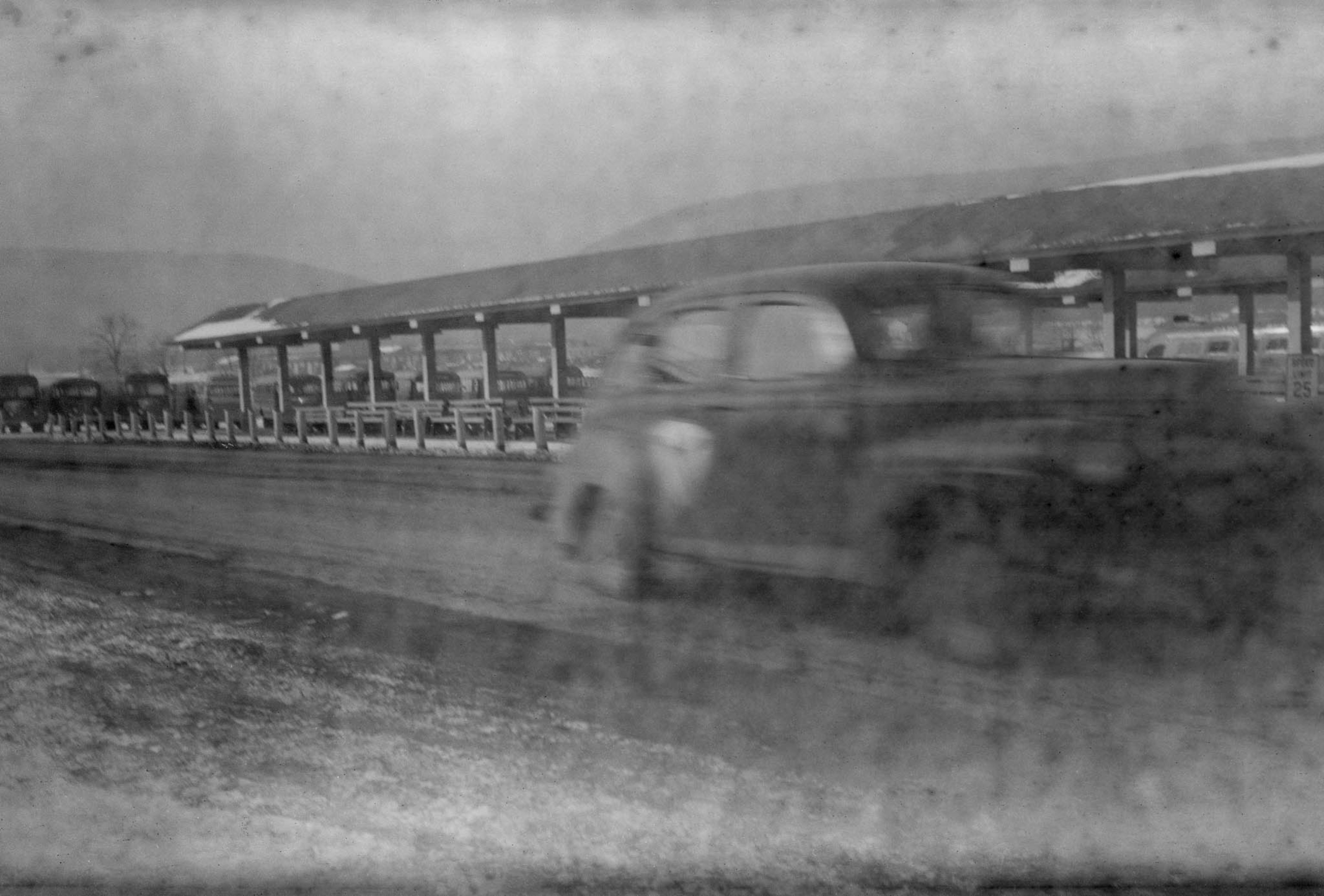 car driving by bus station