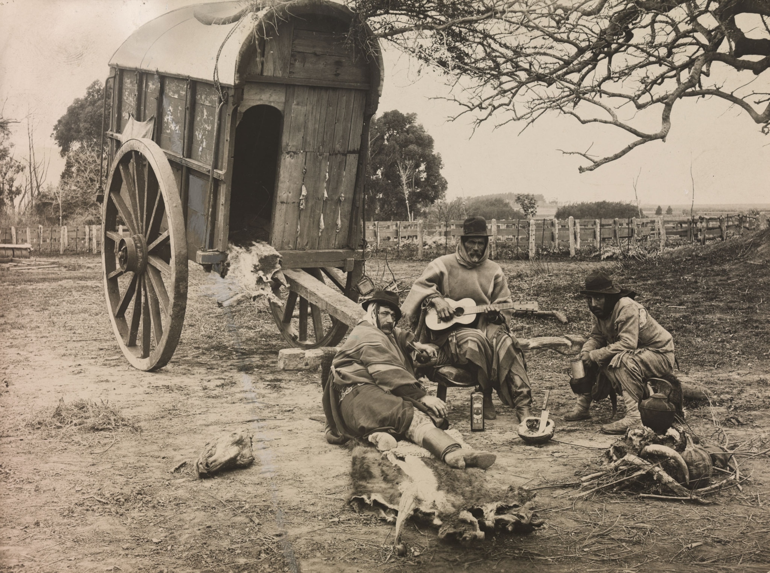 vaqueros sitting near their wagon cart