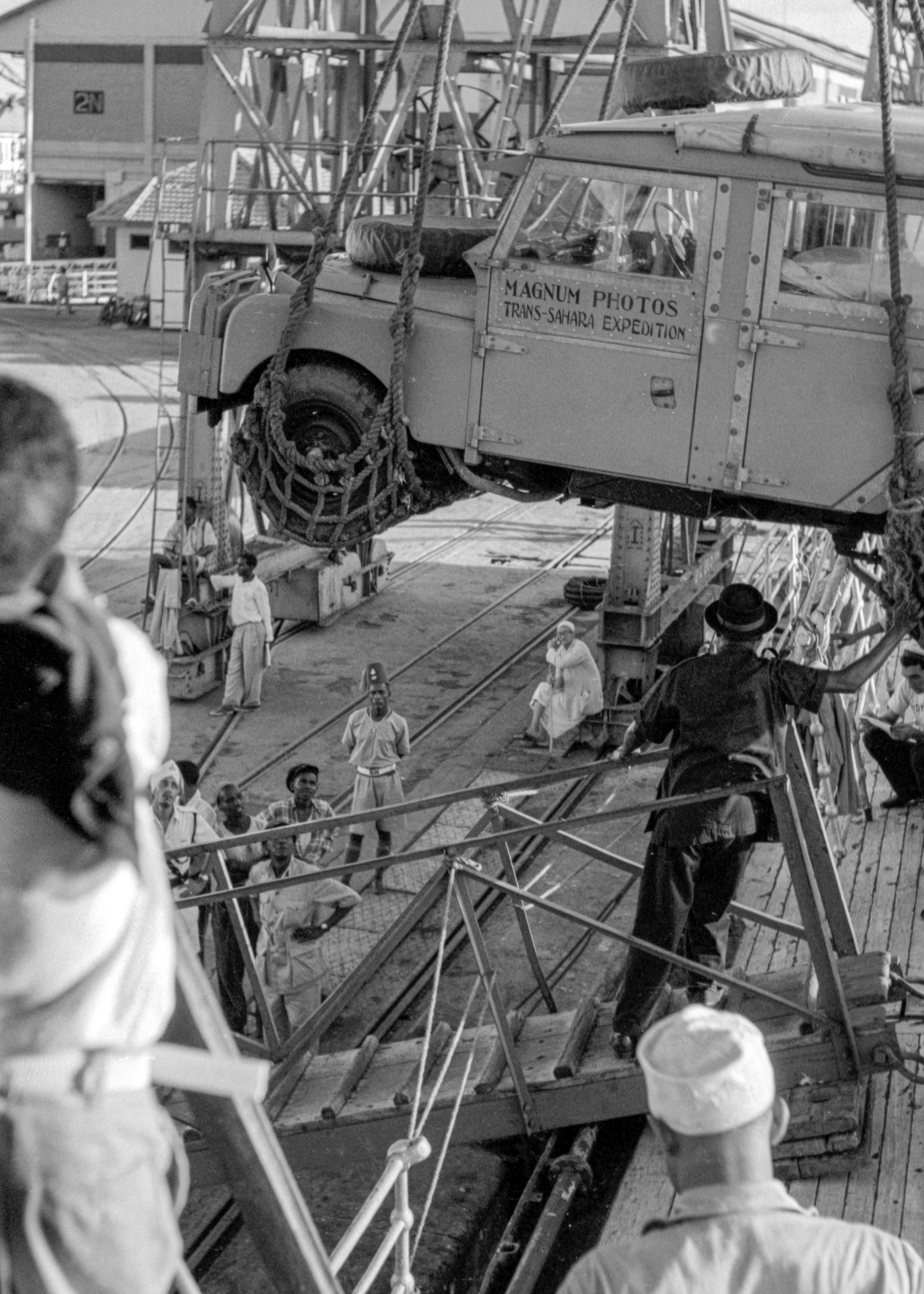 A car being lifted by ropes