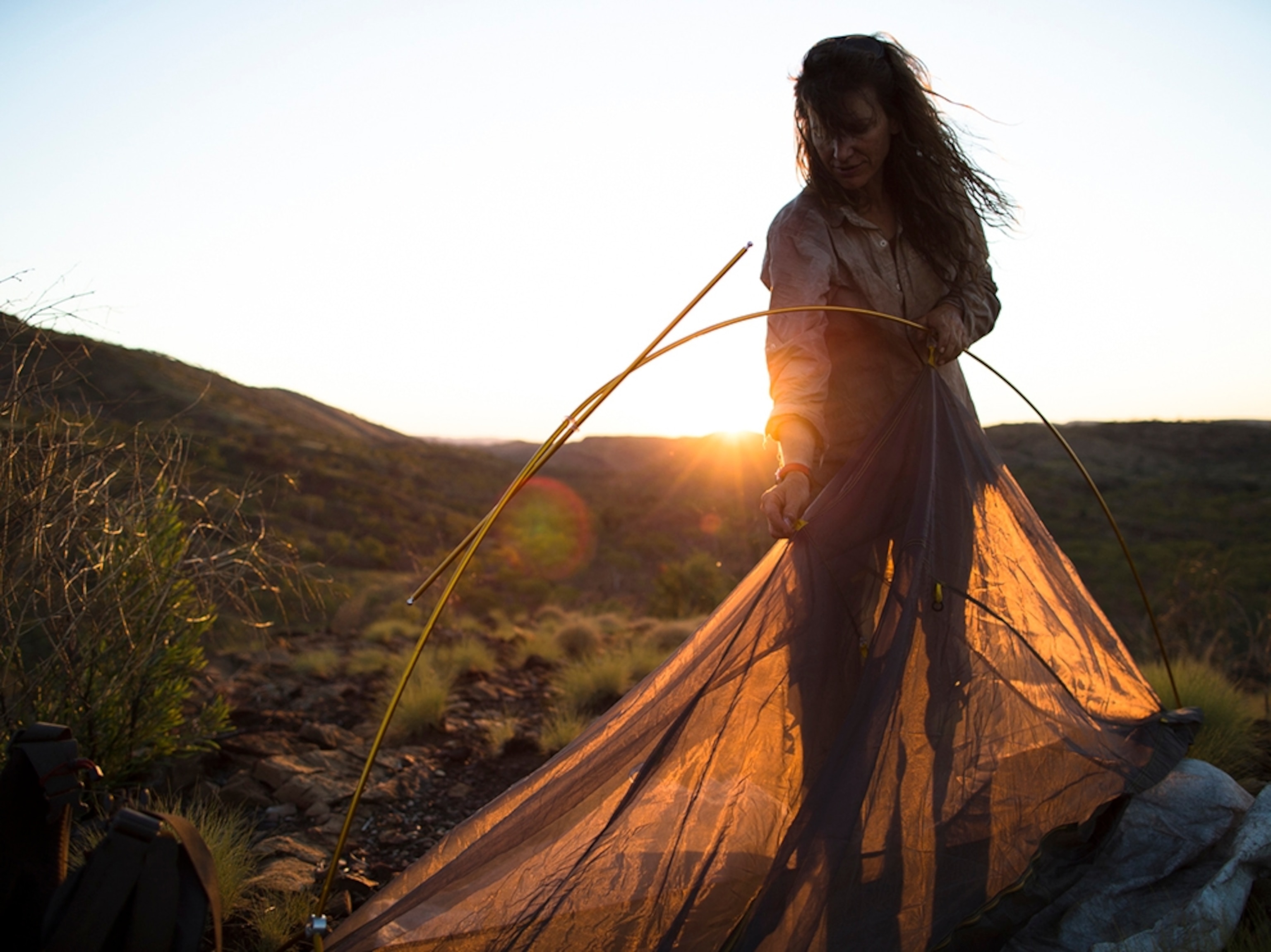 Sarah Marquis pitching a tent in Western Australia.