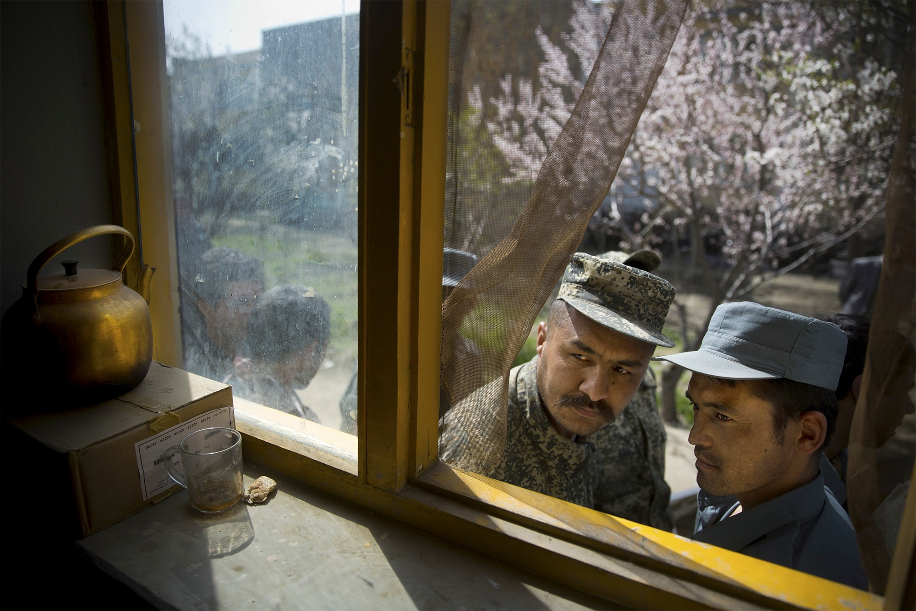 an Afghan National Police officer manning a checkpoint.