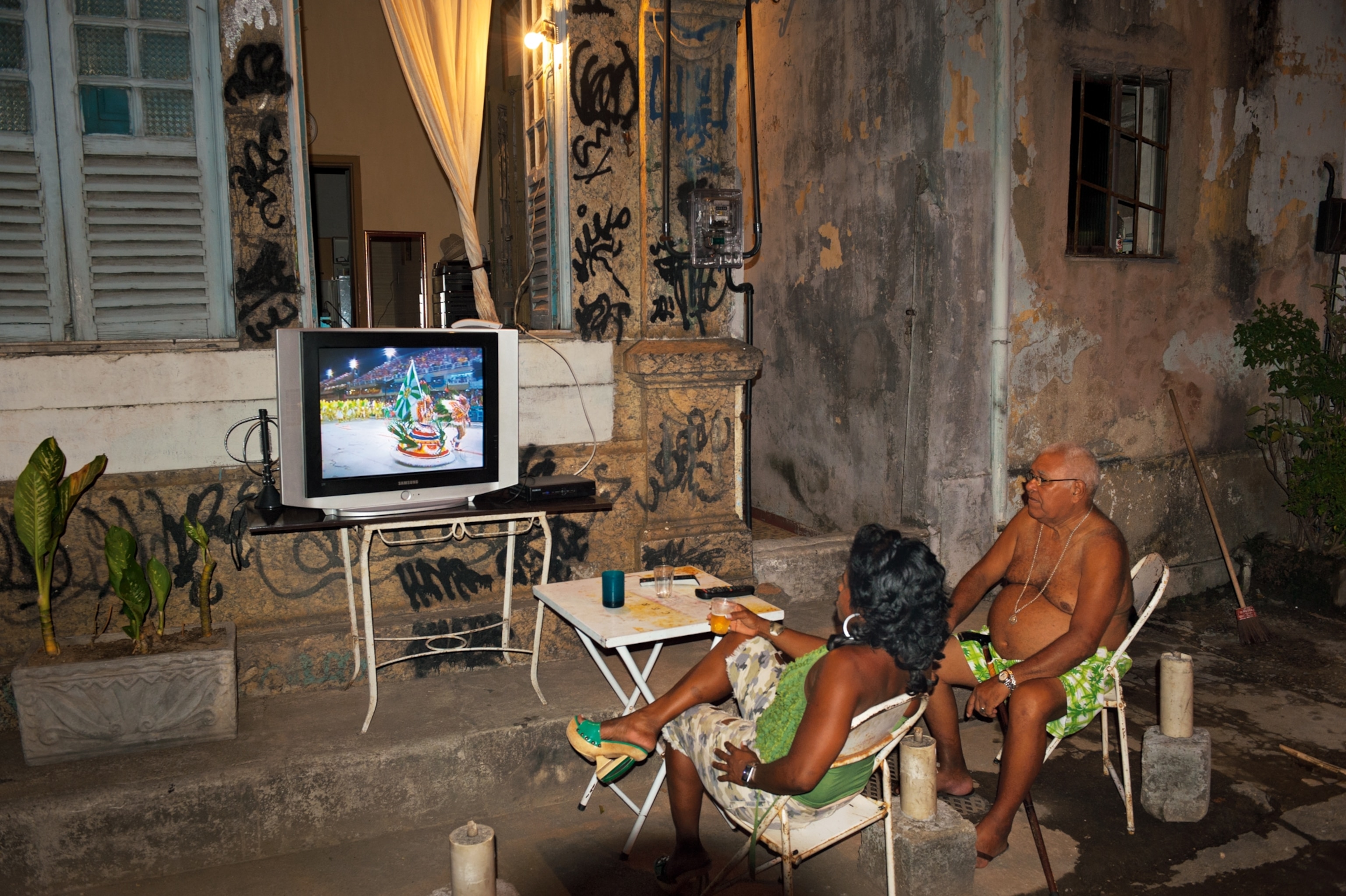 neighbors gathered curbside to watch Carnival parades on TV