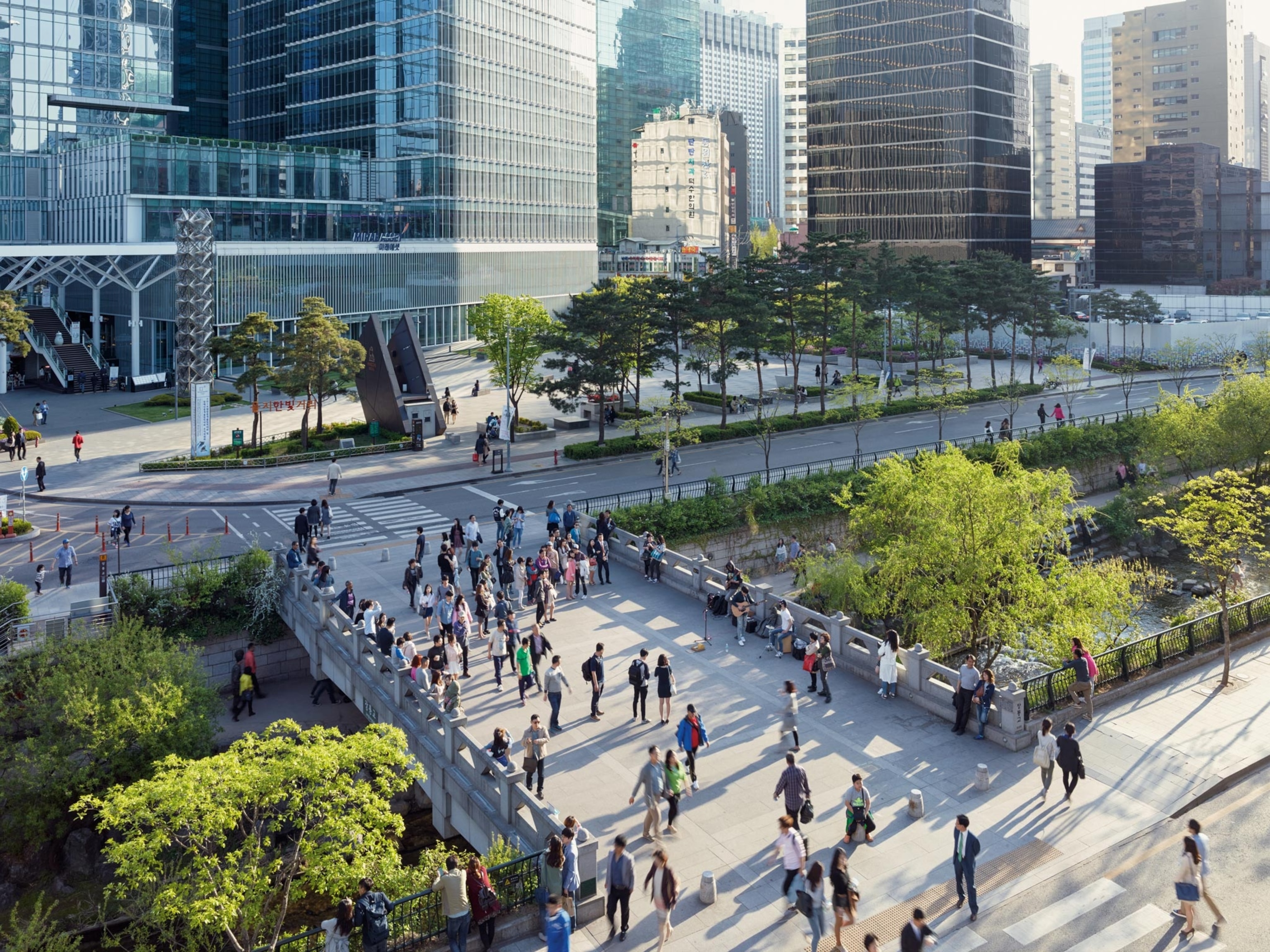 commuters on pedestrian bridge in Seoul, South Korea