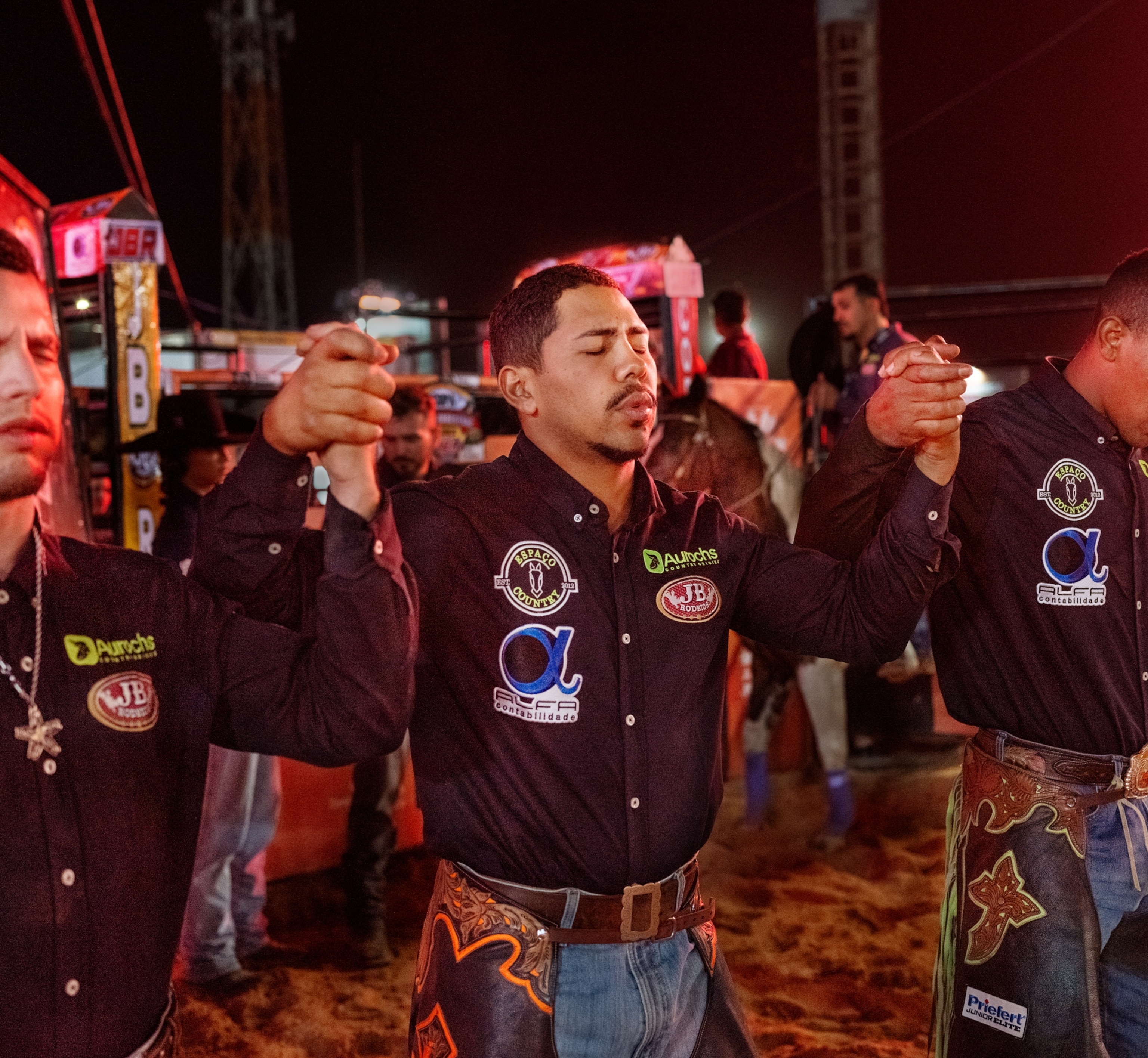 Men are holding hands while reciting in unsion.