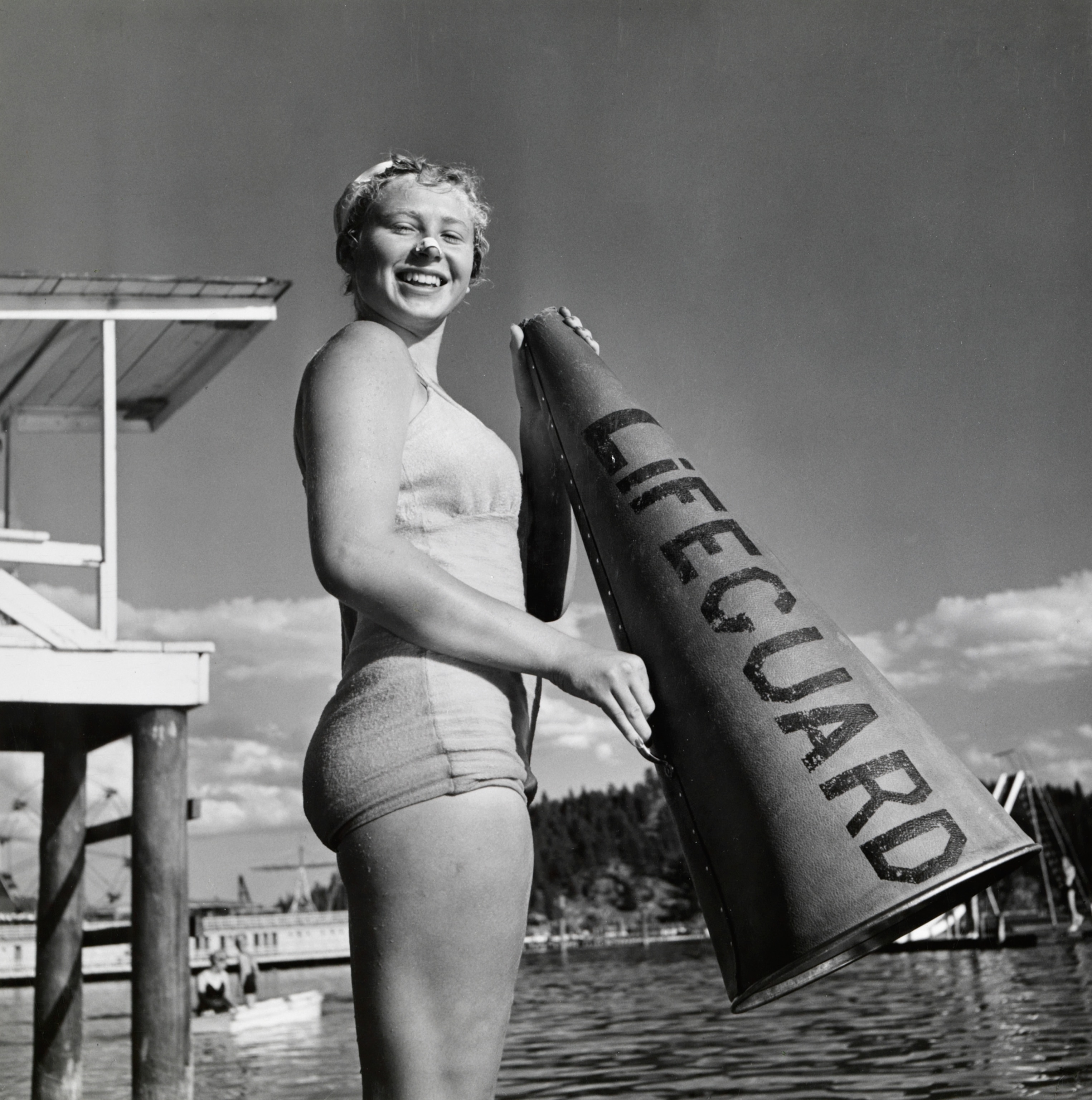 A young female lifeguard holds a megaphone, 1943.