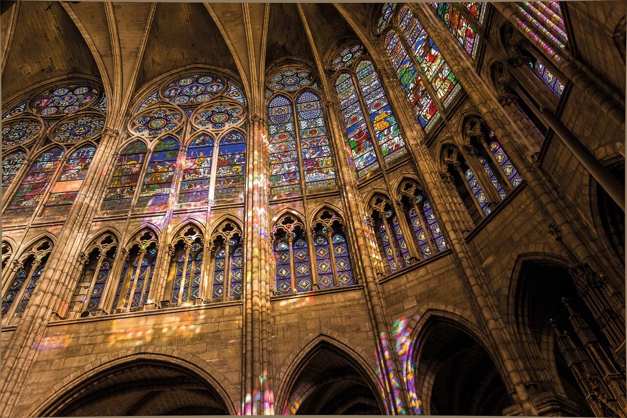 The large stained glass windows are seen inside the Basilique Cathédrale de Saint-Denis