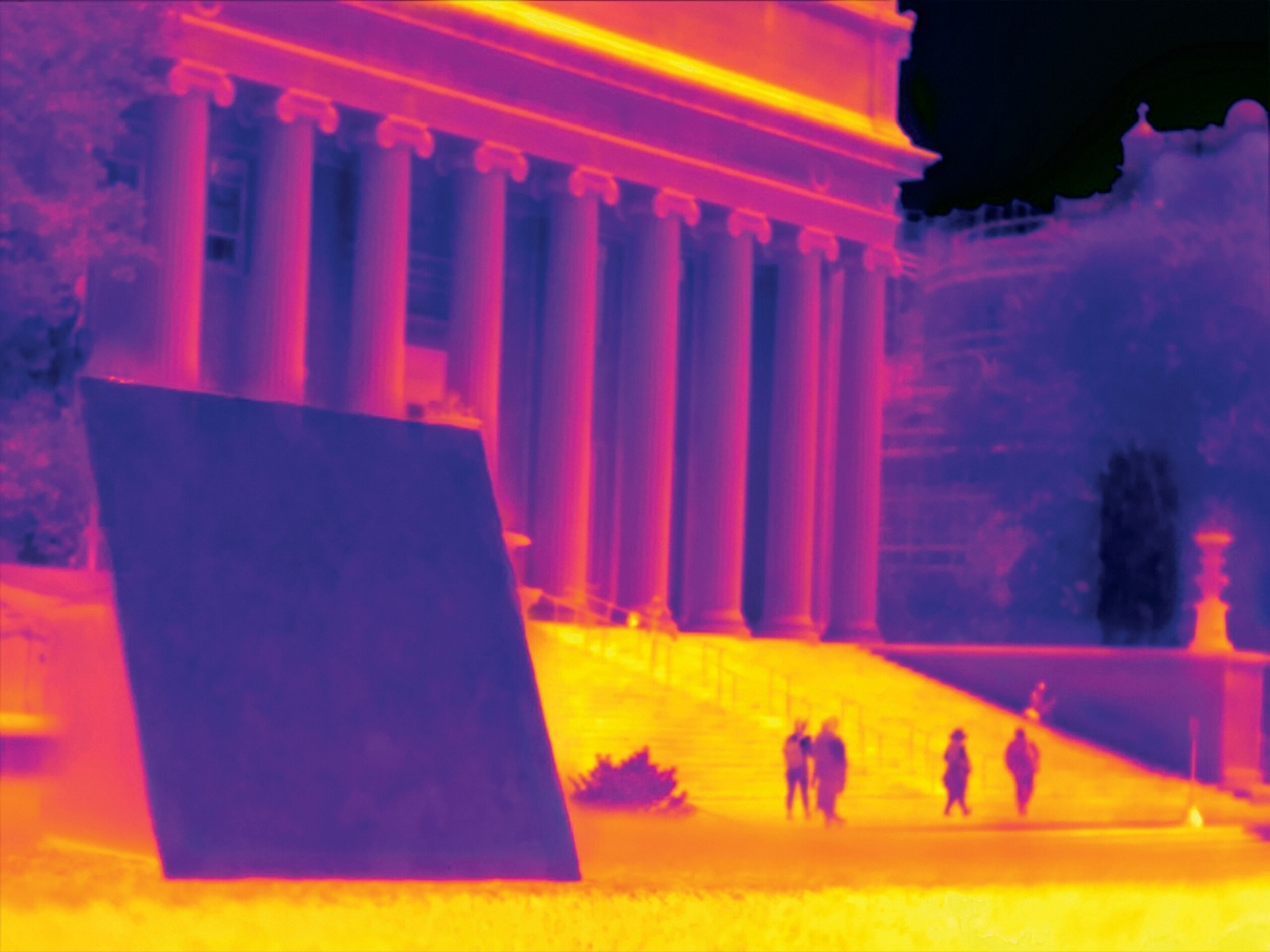 an infrared map image showing a cool blue panel and the yellow and orange hot sidewalks with a red and orange medium hot building in the background